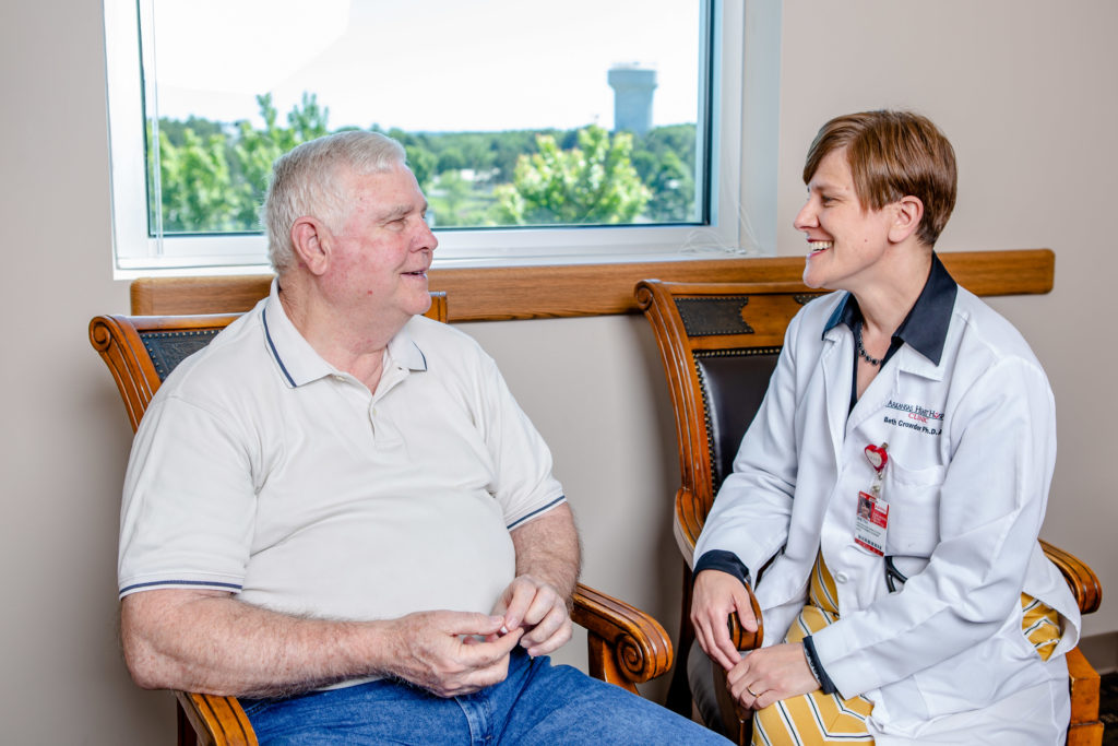 Beth Crowder, APN, talks with patient